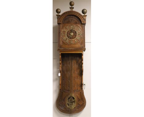 A Frisian tail clock, Friesland, mid 19th century. Carved oak case with Frisian carving and text 'Time goes fast - spend it w