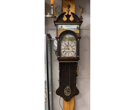 A double hooded tail clock with curved tympanum crown of Atlas and trumpet-blowing angels, 1st half 19th century. Oak case, e