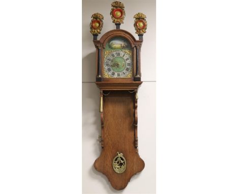 A so-called office or notary's clock, Friesland, 19th century. Oak case, the curved hood is crowned by two gilded trumpet-blo