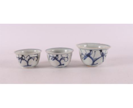 Three blue and white porcelain wine mugs, China, 18th century. Blue underglaze decoration of birds on a branch, largest mug h