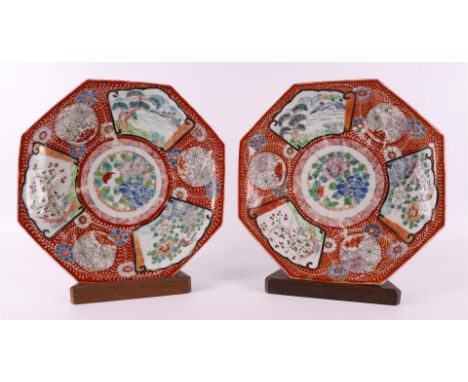 A pair of porcelain octagonal dishes on a stand ring, Japan, Meiji, late 19th century. Polychrome floral decor and landscape 