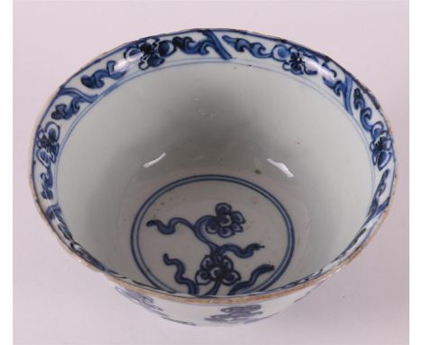 A blue and white porcelain bowl on a stand ring, China, 18th century. Blue underglaze floral decor, relief of lotus motif on 