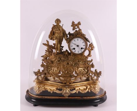 A gilded white metal mantel clock with a composition of, among others, a young man with a scythe, under a glass bell jar, Fra