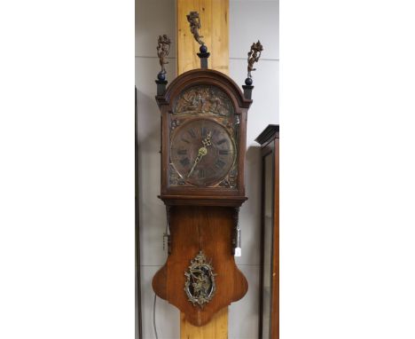 Half a Frisian tail clock, so-called short tail, early 19th century. Oak case, curved hood crowned with gilt pewter basket su