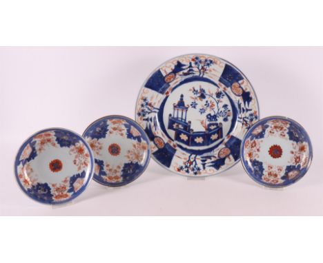 A Chinese Imari porcelain dish, China, Kangxi, early 18th century. Blue/red, partly gold-heightened decor of a pagoda in a ga