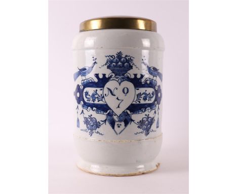 A Delft blue pottery albarello apothecary jar with brass lid, Holland 18th century. Decor of cartouche crowned with peacocks 