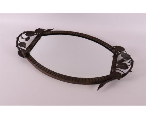 A wrought iron Art Deco salver, France, ca. 1920. Decor of stylized flowers, faceted mirror as tray, l58 x w 32 cm.