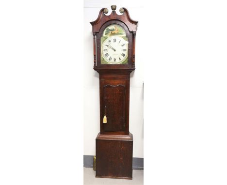 A longcase clock in an oak case, England 19th century. Volute tympanum shade supported by double columns, pendulum case with 