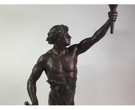 BRONZED FIGURAL TABLE LAMP in the form of a male figure holding a torch, on resin base70cm high