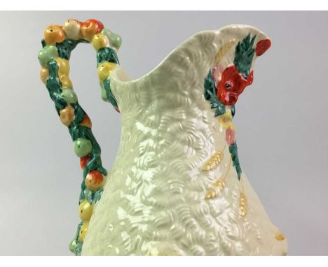 CLARICE CLIFF WATER JUG, CELTIC HARVEST PATTERN  with fruit decorated loop handle28cm highGood overall condition with no obvi