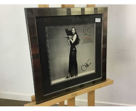 CHER : DARK LADY framed print, along with a framed and signed photograph of Kylie Minogue, both framed and under glassthe Che