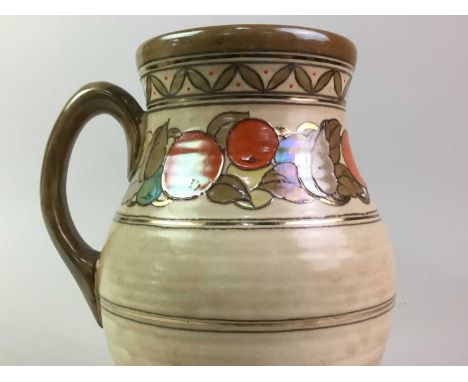 CROWN DUCAL LOTUS TYPE JUG, IN THE STYLE CHARLOTTE RHEAD  with tube lined stylised fruit and floral decoration22cm high