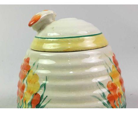 TWO CLARICE CLIFF PRESERVE POTS WITH COVERS, CIRCA 1930s  one of beehive form in the crocus pattern, the other of cylindrical