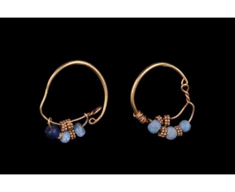 Ca. AD 100-300.A lovely pair of gold hoop earrings comprising medium-sized hoops, each with strands of blue glass and gold fi