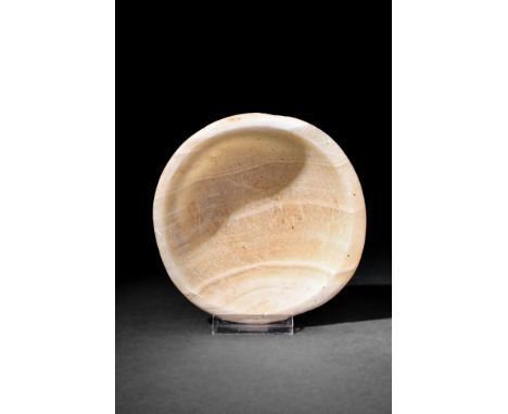 Old Kingdom, Ca. 3000-2345 BC.An alabaster bowl featuring a rounded base, and smooth corsetted walls that gracefully curve in
