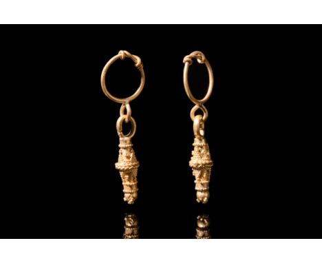 Ca. 300-100 BC.A beautiful pair of gold earrings crafted with meticulous precision. The earrings are comprised of gold, round