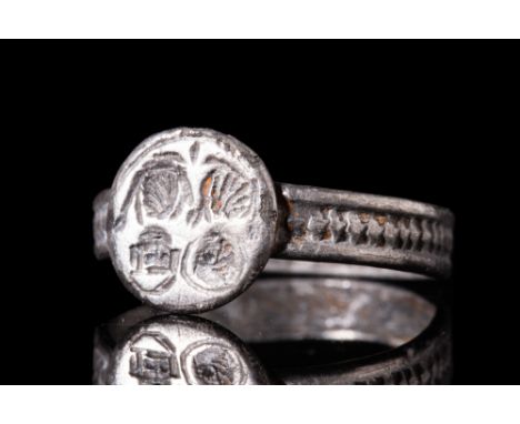 Ca. AD 7th century.An intricate silver finger ring that is incised with two lovely portraits. This ring is comprised of a rou
