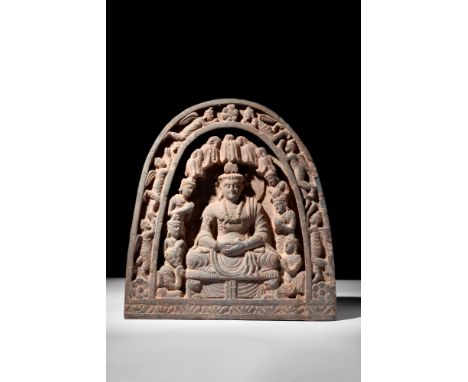 Ca. AD 200-300.A grey schist panel with an ornate, arch-shaped frame. The panel depicts bodhisattva Maitreya abiding in Tushi