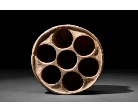 Ca. 2000 BC.A stone vessel characterized by its cylindrical shape, featuring slightly corsetted walls that rise vertically fr