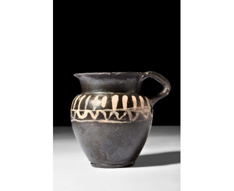Ca. 350 BC.A charming black-glazed xenonware olpe, used to distribute liquid from a large mixing bowl. It is decorated around