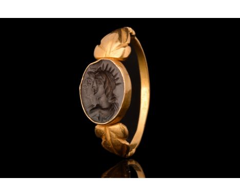 Ca. 2nd Century AD.A gold finger ring of a thin band with a rounded exterior, decorative flared shoulders and an oval-shaped 