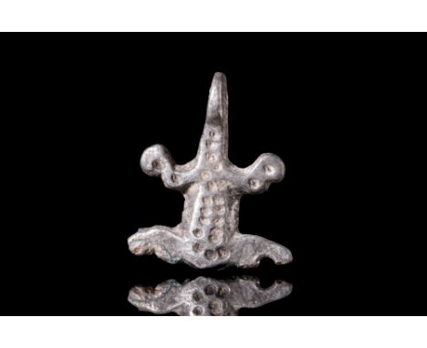 Ca. 300-100 BC.A silver frog amulet, crafted with meticulous detail. This diminuitive charm is carefully rendered, with the b
