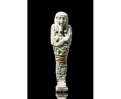 Late Period, Ca. 664-332 BC.Fashioned from light faience, this ushabti of the mummiform stands atop a petite and flat base. T