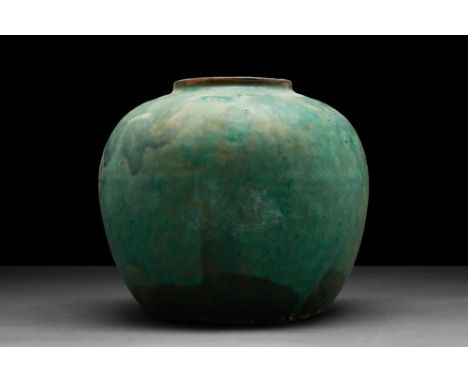 Ming Dynasty, Ca. AD 1368-1644.A large ceramic vessel with a raised rim and a bulbous body gently tapering to a flat base; to