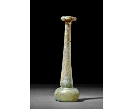 Ca. 1st-2nd century AD.A blown candlestick unguentarium with a short domed body and a long tubular neck terminating in a thic