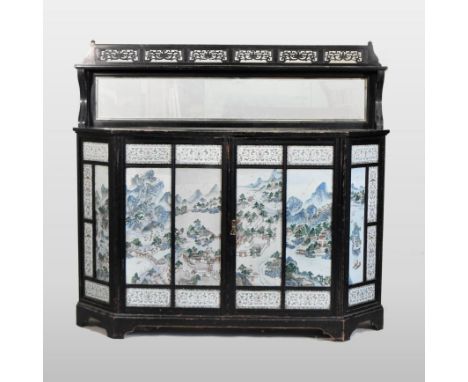 A 19th century ebonised chiffonier, with a pierced gallery back, enclosed by panelled doors, inset with Chinese famille verte