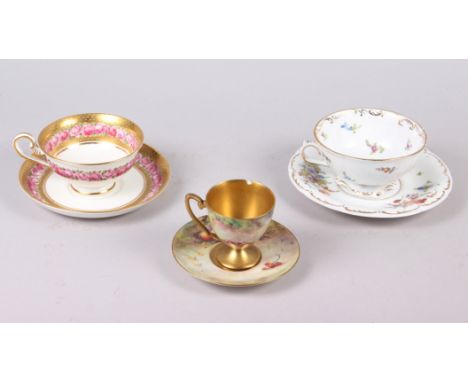 A Royal Worcester cabinet cup and saucer, painted fruit, by T Lockyer (chip to rim) and two other cabinet cups and saucersCon