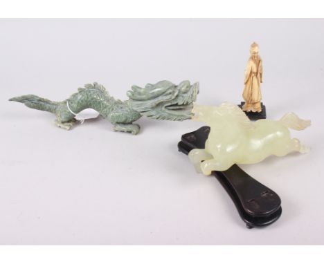 An Oriental jadeite carving of a dragon, 10" long, another jade carving of a horse (leg broken), on wooden stand, and an ivor