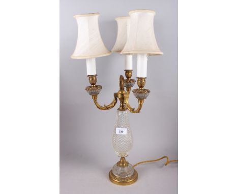 A gilt metal three-light candelabrum with cut glass body fitted electric light