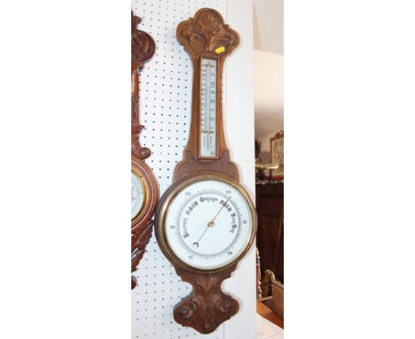 A Victorian aneroid barometer and thermometer, in carved oak case, 31" high 