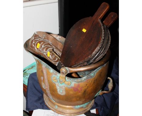A copper helmet coal scuttle, a pair of wooden bellows, a copper Art Nouveau crumb scoop and a copper hunting horn 