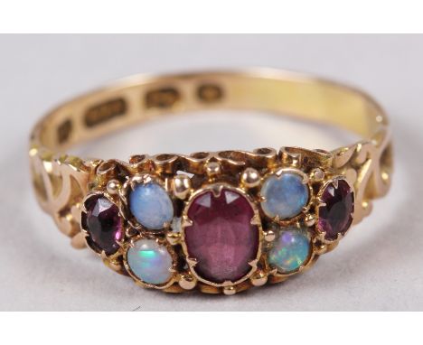 A late 19th century 15ct gold, ruby and opal dress ring with engraved shank, 1.9g, size P 