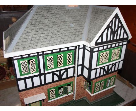 A Tudor style doll's house with part furnished interior, wired for lighting, 23" wide 