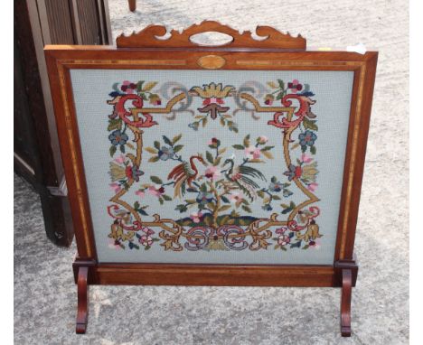 An Edwardian satinwood banded and inlaid mahogany framed firescreen, inset tapestry panel of two birds, 27" wide 