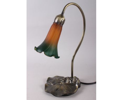 A Tiffany design table lamp with orange and green coloured glass shade, on a metal base formal as a leaf, 14" high 