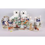 A pair of 19th century Staffordshire spaniels, 11" high, and eight Staffordshire pottery groups