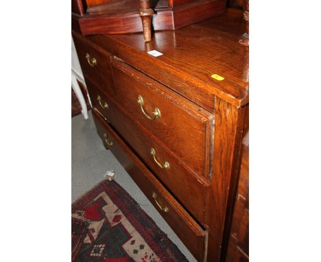 An oak chest of two short and two long drawers, on stile supports, 39" wide x 17" deep x 32 1/2" high, and a light oak finish