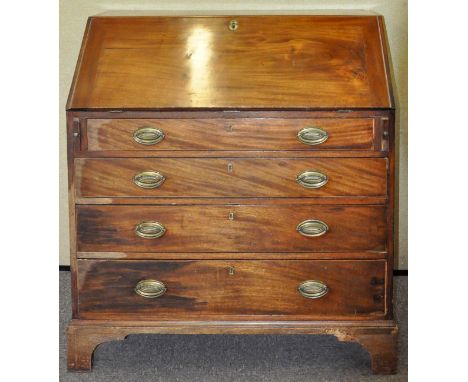 A 19th Century mahogany bureau having a fall front door revealing a fitted interior, above a run of four drawers each with sw