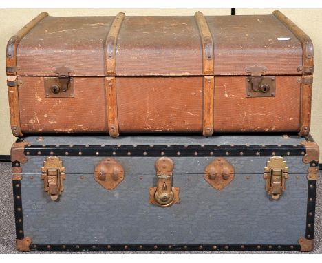 A canvas and wooden bound steamer trunk along with another trunk