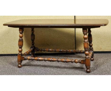 An Ercol 1960's retro vintage 'Old Conolian' elm coffee table, finished in the dark stained colourway, label still present. M