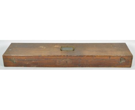 A vintage stained oak rectangular gun case with brass campaign style handle atop, the hinged lid revealing a lined interior. 