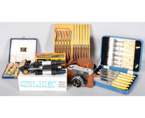 A collection of flatware and camera items