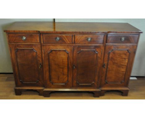 A reproduction Mahogany breakfront sideboard having two central drawers above a twin door cupboard flanked to either side by 