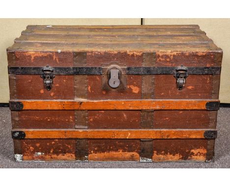 An early 20th century travelling trunk, with giltwood mirror/picture frame and remaining contents of trunk
