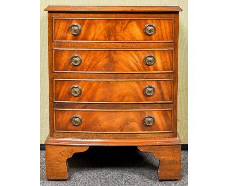 A small regency revival chest of drawers having four drawers each with loop handles, all raised on bracket legs. Measures; 40