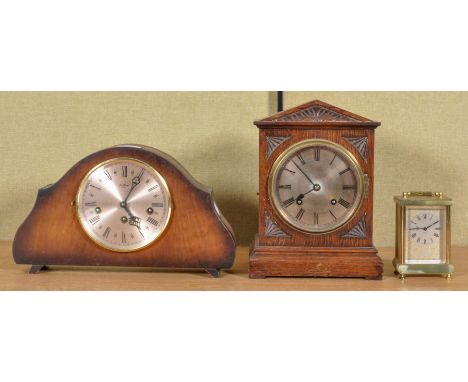 Three 20th Century clocks to include; oak pointed pediment mantel clock, oak cased mantel clock and an onyx and brass carriag